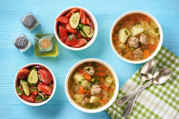 Vegetable soup with meatballs and tomato salad.