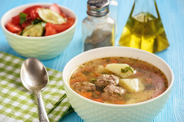 Vegetable soup with meatballs and tomato salad.