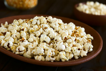 Frischer hausgemachter Popcorn mit Käse, Salz, Knoblauch und Oregano, fotografiert mit natürlichem Licht (Selektiver Fokus, Fokus in die Mitte des Bildes)