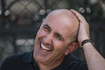 Bald man shows his funny head.