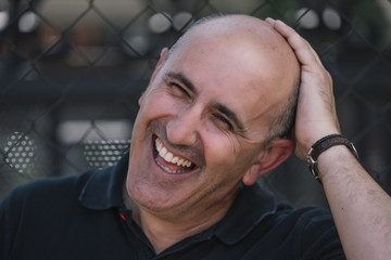 Bald man shows his funny head.