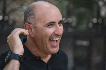 Bald man shows his funny head.