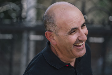 Bald man shows his funny head.