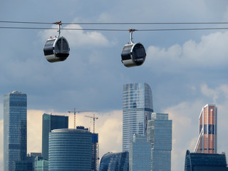New cable car cabins in the Luzhniki against skyscrapers of Moscow-city in Russia