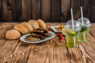 Tasty hamburger with meat and vegetables against a dark background. Fast food. It can be used as a background