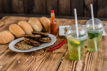 Tasty hamburger with meat and vegetables against a dark background. Fast food. It can be used as a background