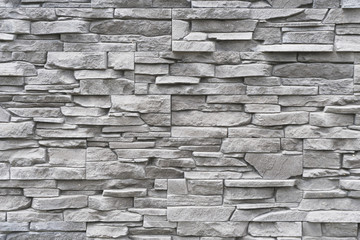 modern architectural detail representing gray decorative brick surface with irregular texture
