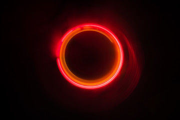 Music concept. Freezelight glowing vinyl on dark background or Turntable playing vinyl with glowing abstract lines concept on dark background.