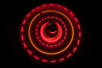 Music concept. Freezelight glowing vinyl on dark background or Turntable playing vinyl with glowing abstract lines concept on dark background.