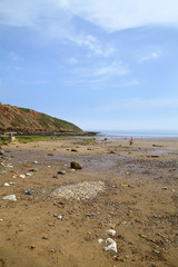 Filey North Yorkshire UK June 1st 2018 view of Filey brigg and carr naze from the beach - Editorial