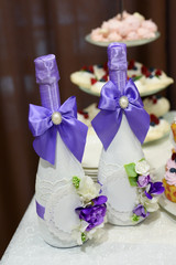 wedding decoration elements, two bottles of champagne decorated with blue silk ribbons bows and flowers