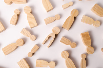 A figurine of a woman with a hole in the shape of a child in her body lies on a white background among other people. The concept of a child lost, the search for a man to create a family. Tragedy