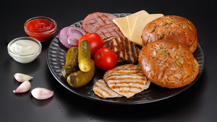 Ingredients for a sandwich on a black background.