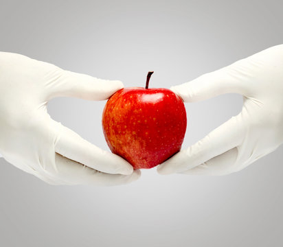 Patient education with fresh apple holding in a hand isolated in white background