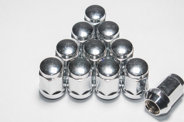 Car service, nut of fixture of a wheel of the car on a white background,