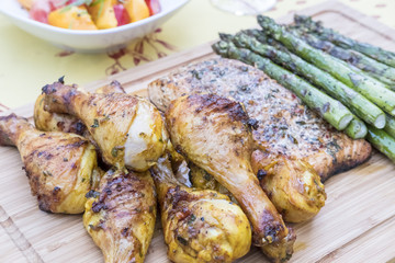Barbecued Chicken, Salmon and Asparagus on a Bamboo Cutting Board