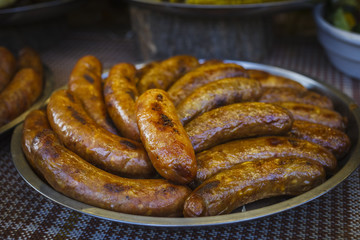 Festival of street food. Dish with grilled sausages