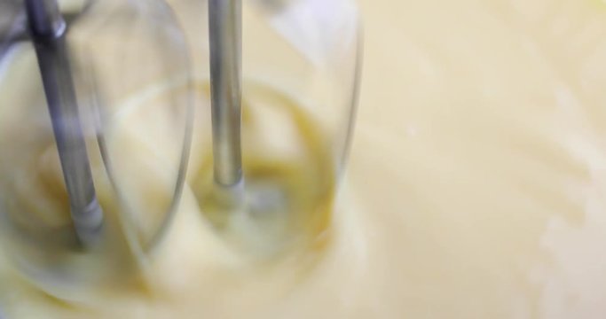 Very close video of banana cream pudding being mixed with dual beaters while rotating the bowl.