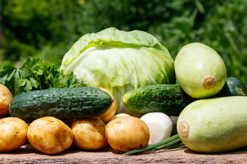 Fresh vegetables on rustic wooden table outdoor