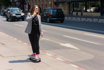 Person with skateboard standing on the path in the city