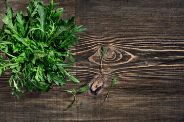 Fresh green arugula on wooden table