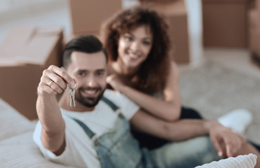 Young couple with a key to a new apartment.