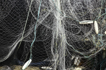 Sea fishing nets drying on railings at the coast