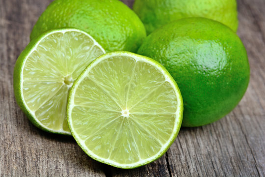 Heap of limes on vintage wood table
