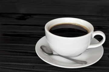 copy spaсe, cup of coffee on a dark wood background