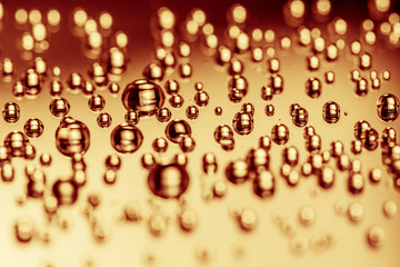 water gold, golden, drops on black background. Macro extreme.
