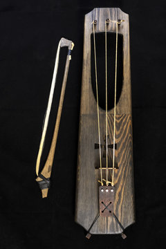 Wooden musical bowed harp instrument of talharpa