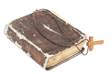 Ancient holy book of a wooden cross on a cord