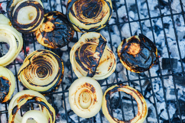 Grilled onion on a grill pan, outdoor top view