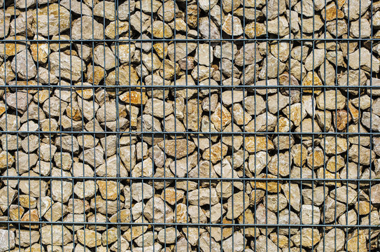 Detail of gabion wall filled with stones
