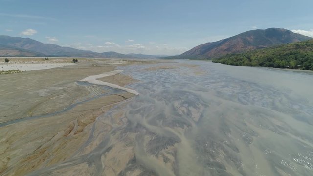 Parched river in mountain province Luzon, Philippines. Aerial view Drought in mountain valley, dry and shallow Bucao river.