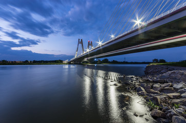 Fototapeta modern bridge over Vistula river, Krakow, Poland, illuminated in the night obraz