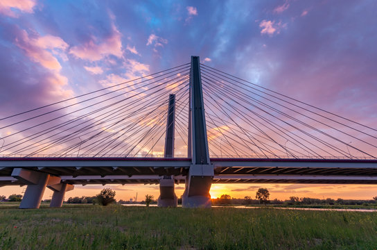 Cable stayed bridge over Vistula river, Krakow, Poland, beautiful colorful sunset