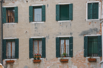 Tradional windows and balconies of an old building in Venice, Italy