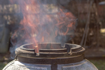 Tandyr oven close up photo on the summer outdoor green garden