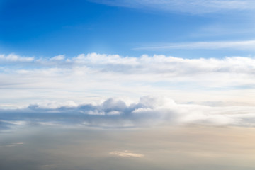 Fototapeta na wymiar Skyline View above the Clouds from Airplane