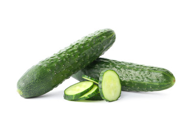 Whole and sliced fresh cucumbers on white background