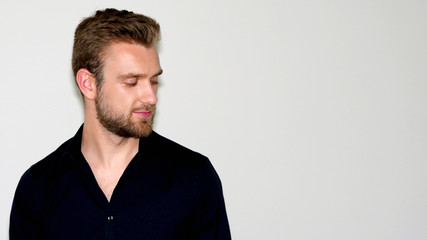 Fototapeta premium Handsome bearded boy looking down