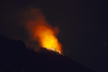 Stromboli volcano eruption during a starry night