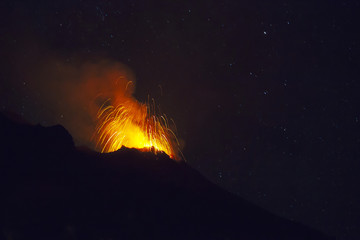 Stromboli volcano eruption during a starry night