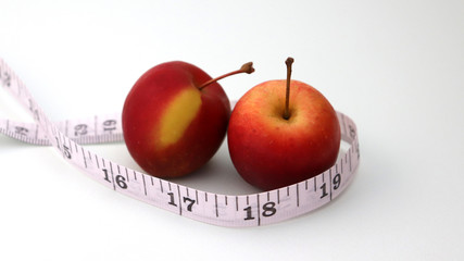Two apples and a tape measure.