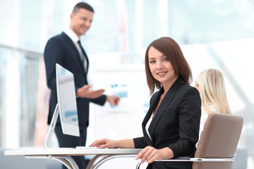 portrait of a successful female assistant sitting at a Desk