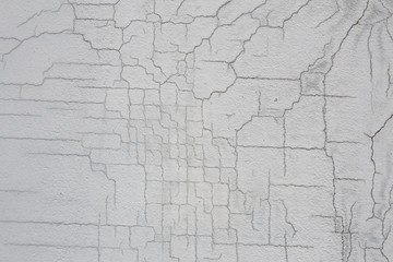 Texture of white dirty cracked wall. Small straight cracks. Direct fracture on painted surface. Cells fissure