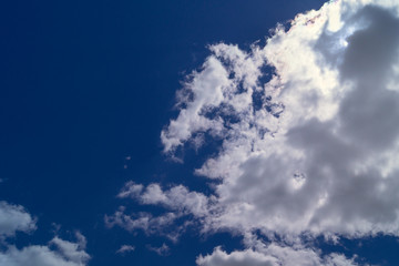 The sky is rich in blue and dense cumulus clouds, summer day, noon, the texture of the sky and clouds.
