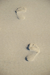 foot prints in the sand looking like a hologram