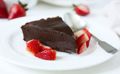 Piece of chocolate cake served with strawberries